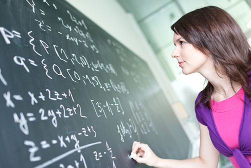 women writing on blackboard